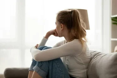 sad-woman-sitting-on-the-couch